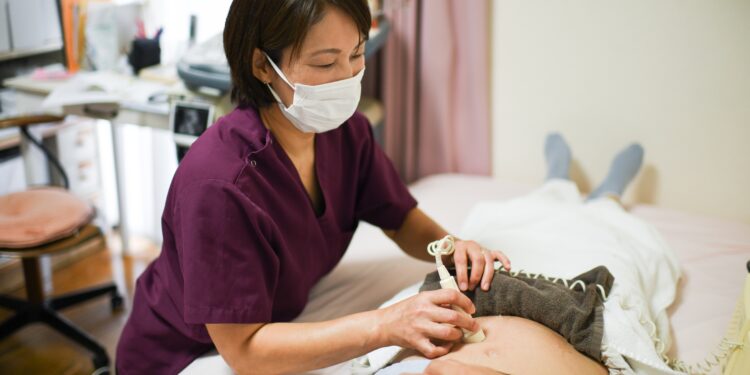 A midwife Yuri Kudo does prenatal checkup at Yajima midwifery Clinic in Tokyo, Japan.